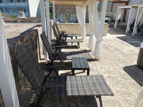 a group of chairs and tables on a roof at Dimora Assuntina Martano in Martano