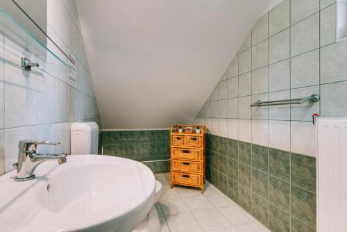 a bathroom with a sink and a toilet at Matild Country Hotel in Nemesvita