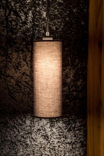a light fixture hanging from a wall at Wohlfühlhotel Berg Heil in Holzgau