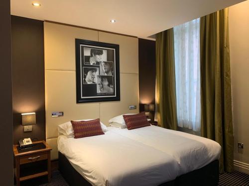 a hotel room with a bed and a window at Hard Days Night Hotel in Liverpool