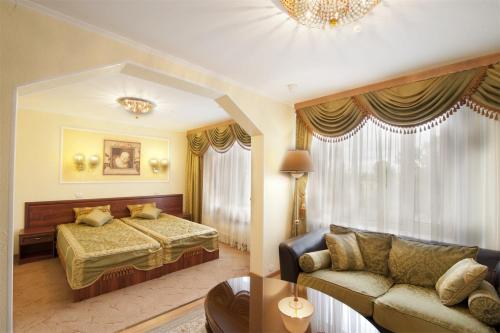 a hotel room with a bed and a couch at Апартаменты Восход in Moscow