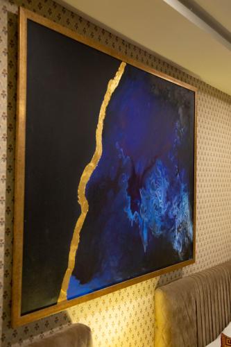 a painting hanging on a wall at Shelton's Ambassador in Islamabad