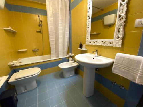 a bathroom with a sink and a toilet and a mirror at B&B Blessed apartment in Perugia
