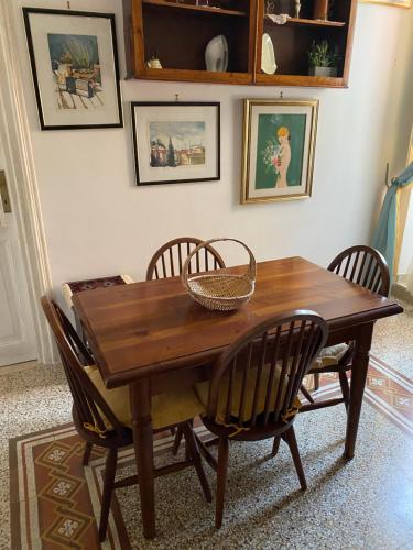 a dining room table with chairs and a basket on it at Edo apartament in Lido di Ostia