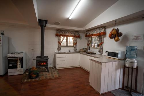 a kitchen with white cabinets and a stove at Glen Mervyn Lodge in Mumballup