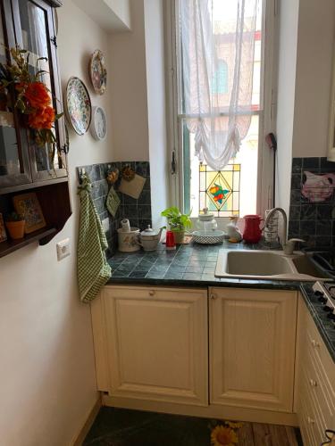 a kitchen with a sink and a window at Edo apartament in Lido di Ostia