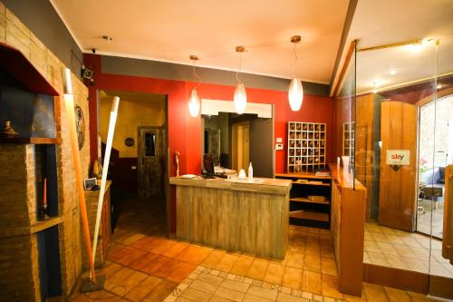 a kitchen with red walls and a counter in a room at Hotel Benedetti in Campello sul Clitunno