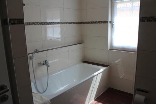 a bathroom with a bath tub with a shower at Appartements Vanii in Rust
