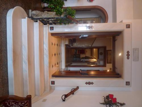 a mirror on a wall in a room at Hotel La Riva in Giardini Naxos