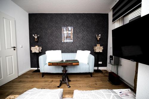 a living room with a couch and a table at Wismarer Heckflosse in Wismar