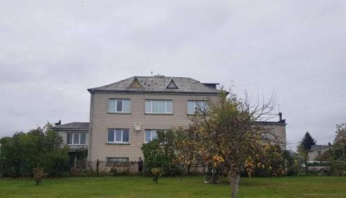 a large brick house with a gambrel roof at Darbuotojų apgyvendimas Karmėlavoje in Karmėlava