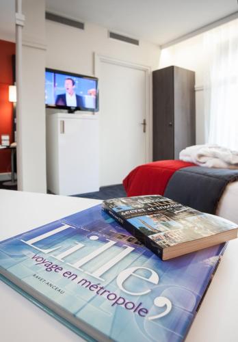 Télévision ou salle de divertissement dans l'établissement Mercure Lille Centre Grand Place