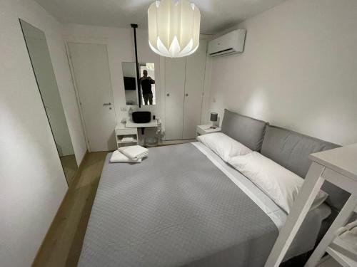 a room with a bed and a person in a mirror at Ale e Franz in Cefalù