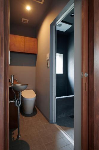 a bathroom with a toilet and a sink and a shower at Shirafuji in Suzaka