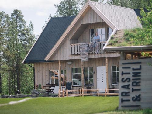 a man standing on the balcony of a house at Trasti & Trine Boutique Hotel in Alta