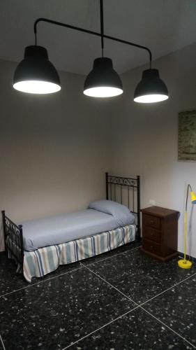 a bedroom with a bed with two lights and a dresser at Bed&BluUp in Savona