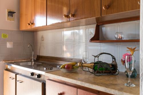 a kitchen counter with a sink and a bowl of fruit at Tasia Studios in Perivolion