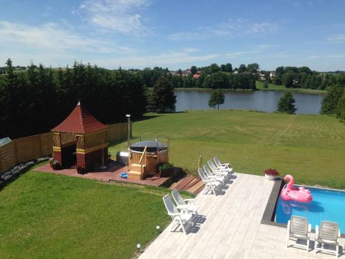 a large backyard with a gazebo and a pool at Willa Puńsk z basenem nad jeziorem in Puńsk