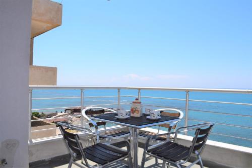 a table and chairs on a balcony overlooking the ocean at Home Sweet Home by the Sea - 060 in Durrës