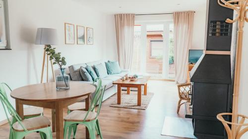a living room with a couch and a table at Lake Park Łagów in Łagów