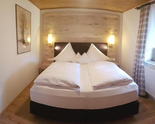 a bedroom with a large bed with white sheets and pillows at Kieslinger Hilde in Arrach