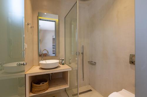 a bathroom with a sink and a glass shower at SpilGaia in Spílion