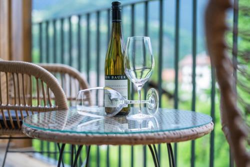 a bottle of wine sitting on a table with a glass at Boutiquehotel - Michl in Sautens
