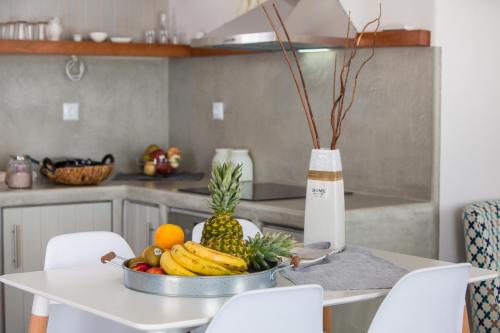 a bowl of fruit on a table in a kitchen at Punda Villas Paros in Kampos Paros