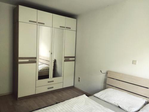 a bedroom with a bed and a large cabinet at Haus Im Grünen in Villach