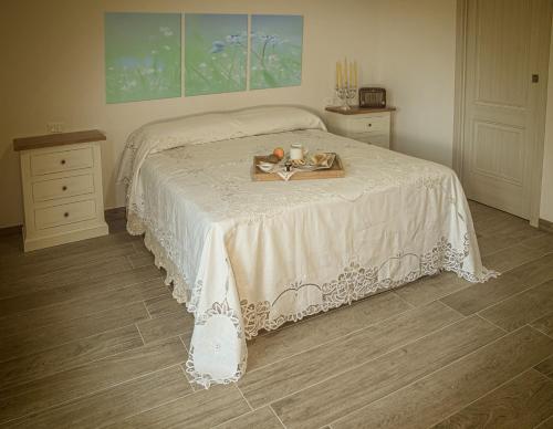 a bedroom with a bed with a tray of food on it at Agriturismo Albero del Miele in San Rufo