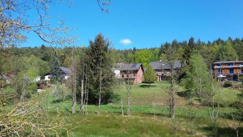 a group of houses in a field with trees at Ferienwohnung Mossauer Hoehe in Mossautal