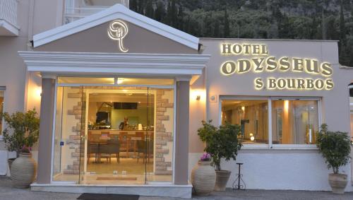 a hotel odysseus and burro store front with a sign at Odysseus Hotel in Paleokastritsa