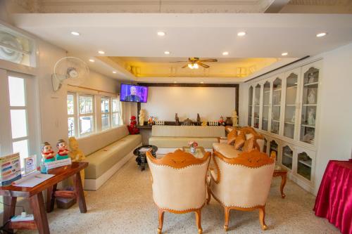 a living room with a table and some chairs at Anchalee Resort in Bang Saphan