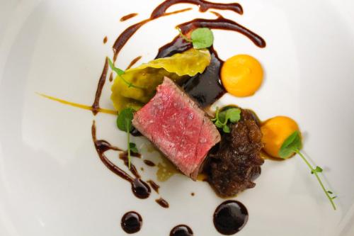 a white plate with a piece of food on it at Bunratty Manor Hotel in Bunratty