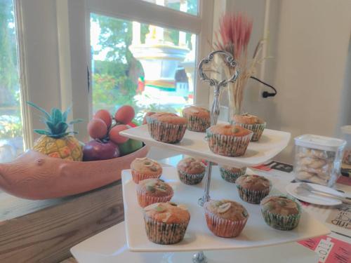 a three tiered display of cupcakes on a table at Anchalee Resort in Bang Saphan