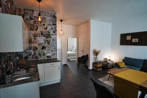 a kitchen and living room with a couch and a table at Appartement Backstage in Rheine