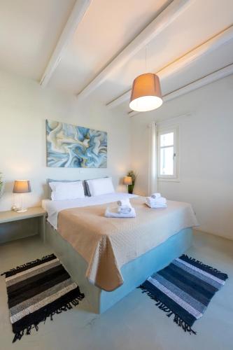 a bedroom with a large bed and a window at Punda Villas Paros in Kampos Paros