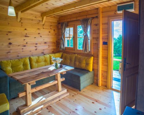 a living room with a couch and a table at Maple village in Žabljak