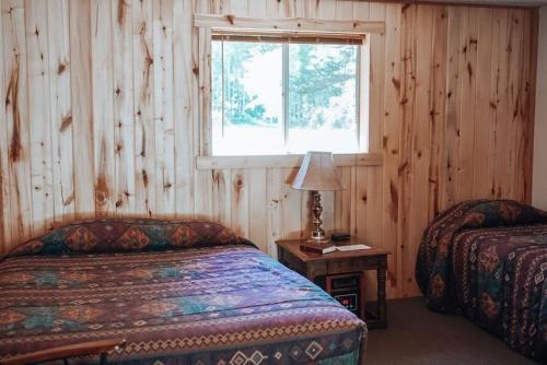 a bedroom with two beds and a window at Circle K Ranch in Rico