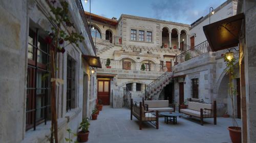 an alley with benches and tables in a building at Harman Cave Hotel in Goreme