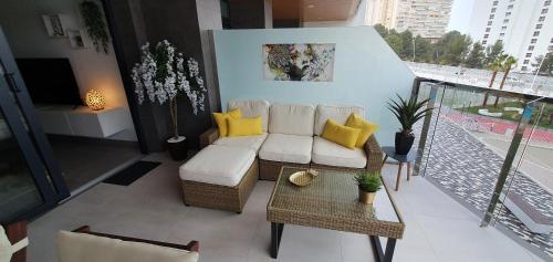 a living room with a couch and a table at Sunset Waves Benidorm by Mar Holidays in Benidorm
