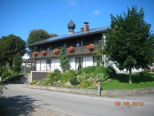 a house with flower boxes on the side of it at Gasthof zur Post in Schonstett