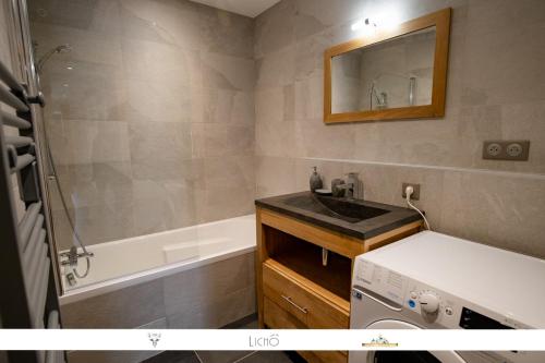 a bathroom with a sink and a bath tub at MARMOTTE 001 - Bel appartement avec grande terrasse, aux pieds des pistes in Bonneval-sur-Arc