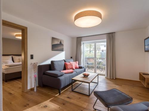 a living room with a couch and a table at Haus Prem in Hopfgarten im Brixental