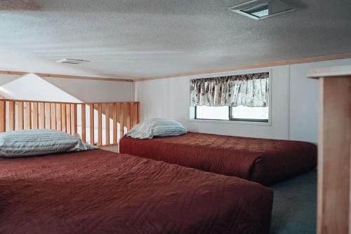 a bedroom with two beds and a window at Circle K Ranch in Rico