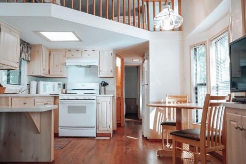 a kitchen with white appliances and a table with chairs at Circle K Ranch in Rico