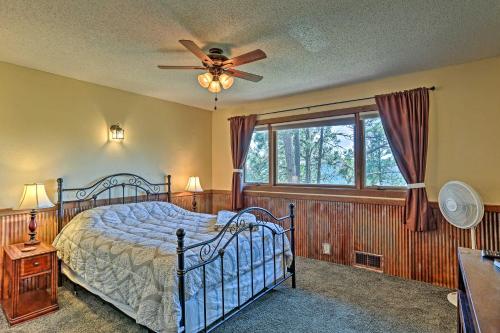 a bedroom with a bed and a ceiling fan at Rustic Black Hills Retreat with Expansive Views in Rapid City
