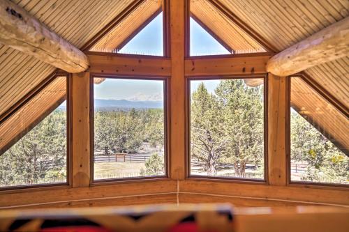 a room with four windows in a wooden building at Bend Log Cabin with Cascade Mountain Views! in Bend