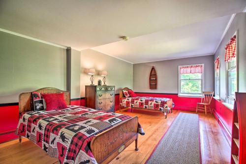 a bedroom with a bed and a couch in it at Vintage Schroon Lake Farmhouse w/ Private Beach! in Schroon Lake