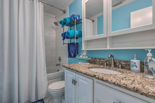 a bathroom with a sink and a toilet and a shower at Stunning Views and Waterfront Fun Aloe Bay Home in Dauphin Island